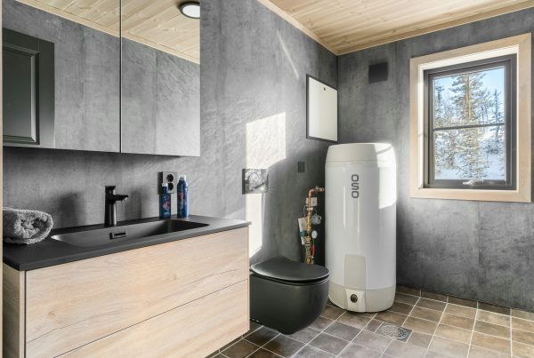 a-bathroom-with-a-toilet-sink-and-a-window